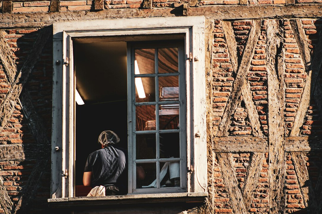 Person writing in a personal journal at a wooden desk