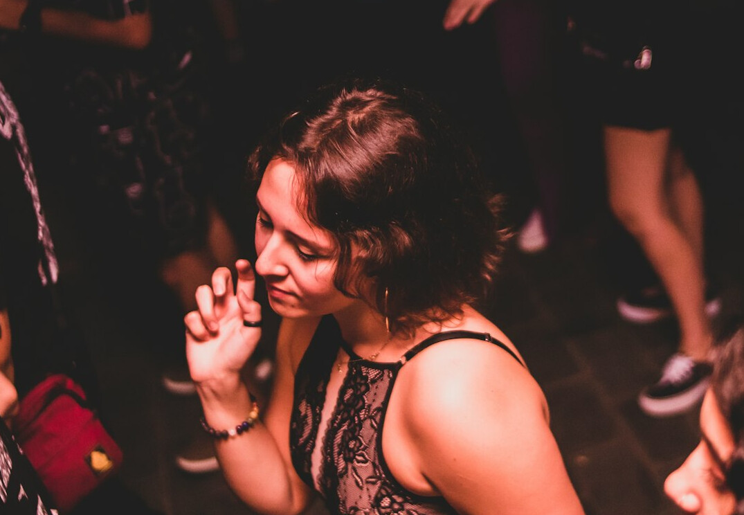 Brazilian woman speaking confidently to a small group indoors
