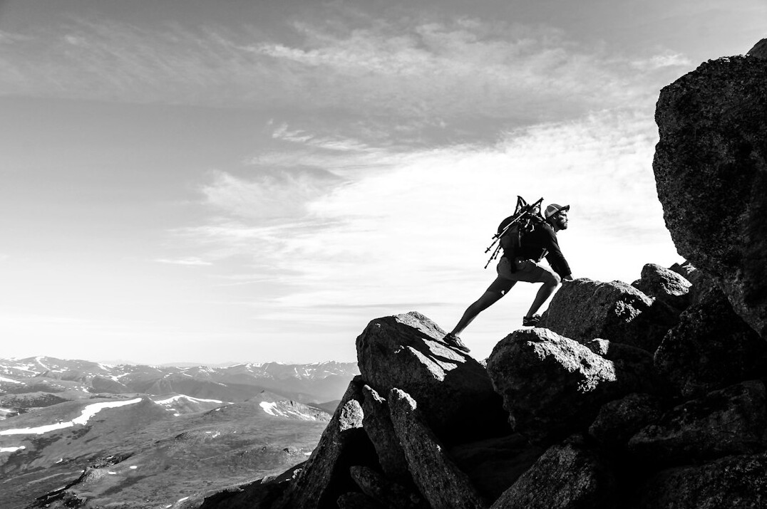 person climbing mountain
